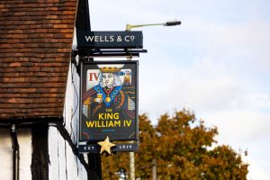 Contact the King William. The Pub sign is hanging from the side of the pub