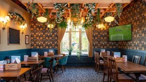 The King William pub restaurant area. Spacious seating and a tv for live sport in the corner